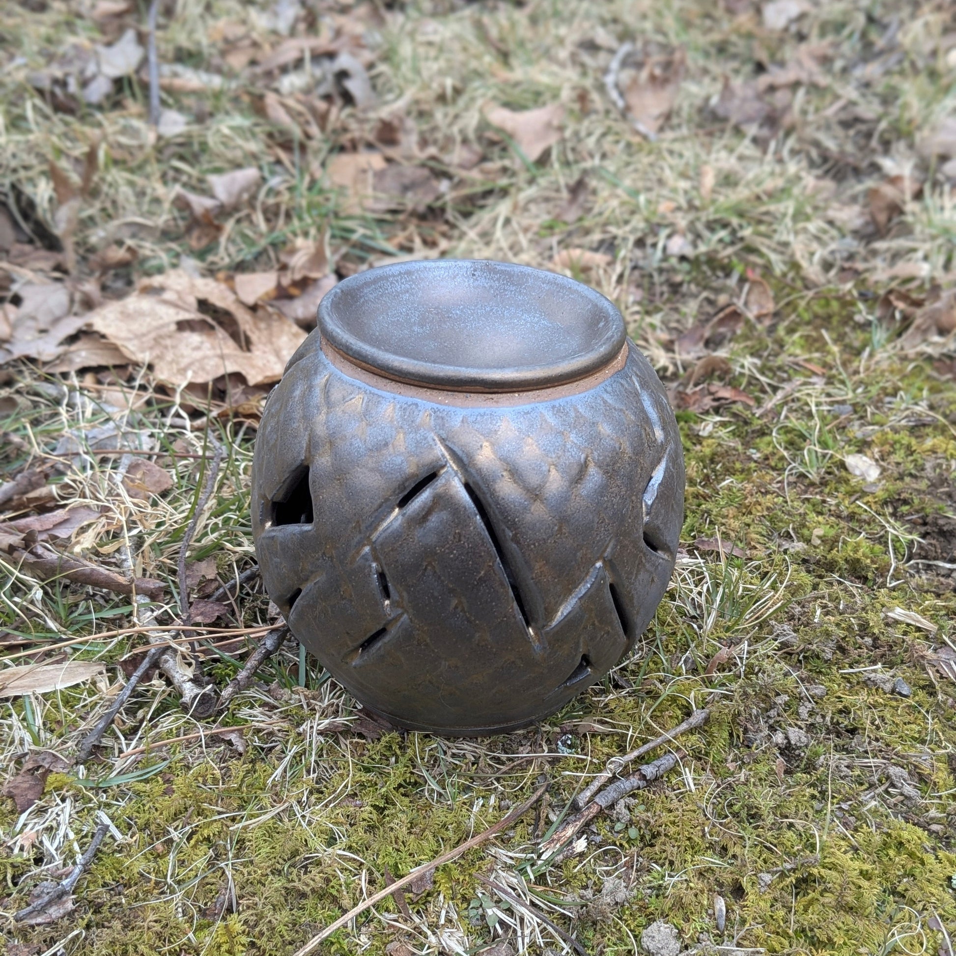 Decorative lantern on a grassy ground with leaves