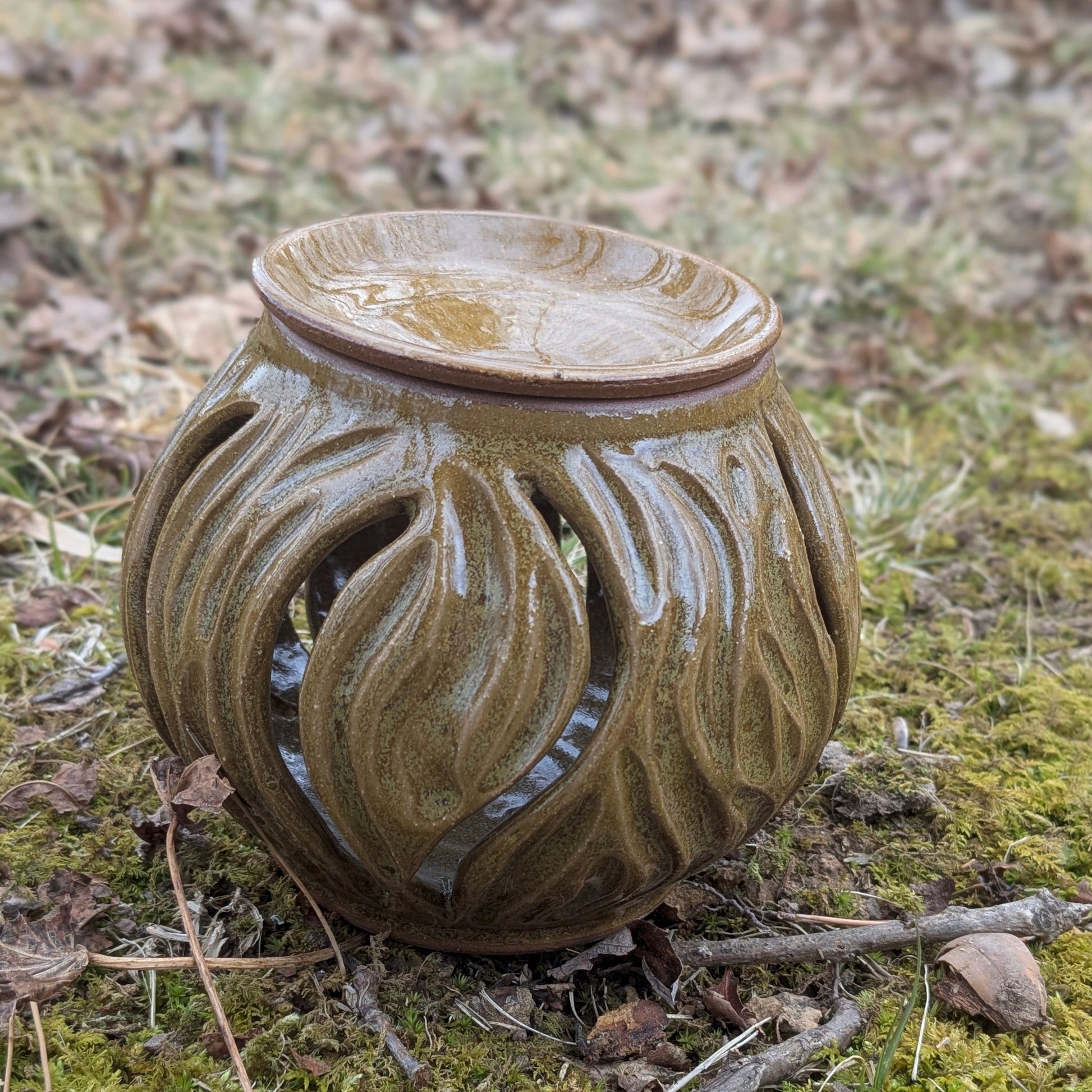 Decorative ceramic lantern on a natural ground cover