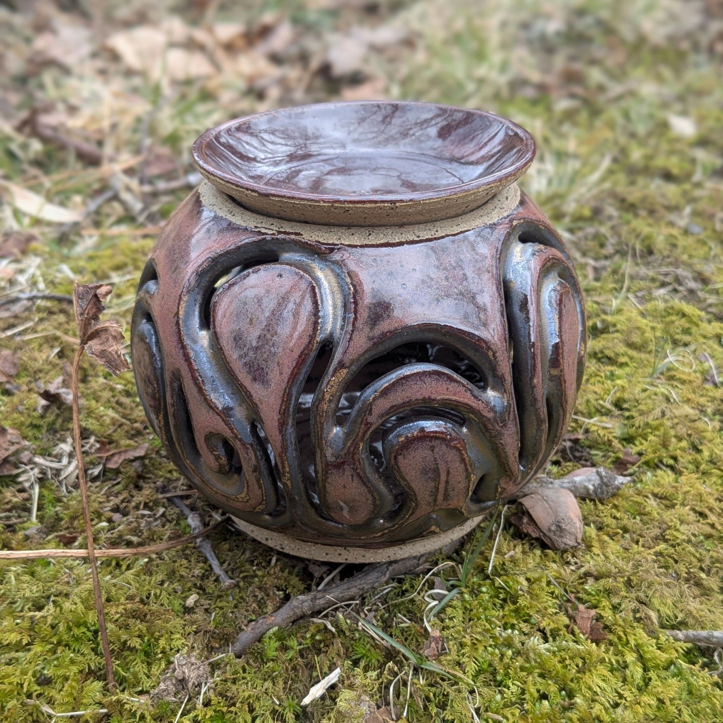 Decorative ceramic lantern on a mossy ground
